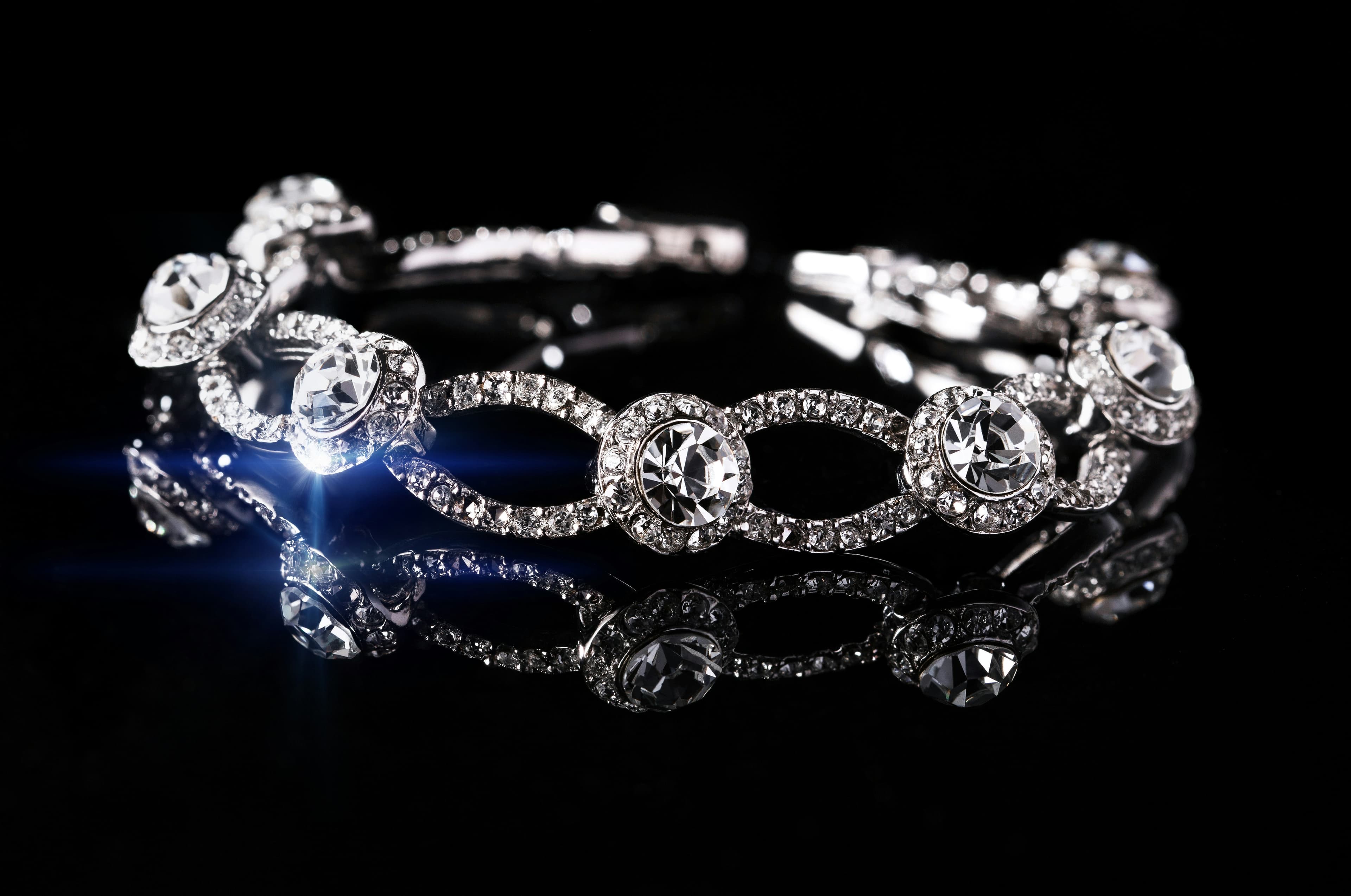 A diamond bracelet catching light on black