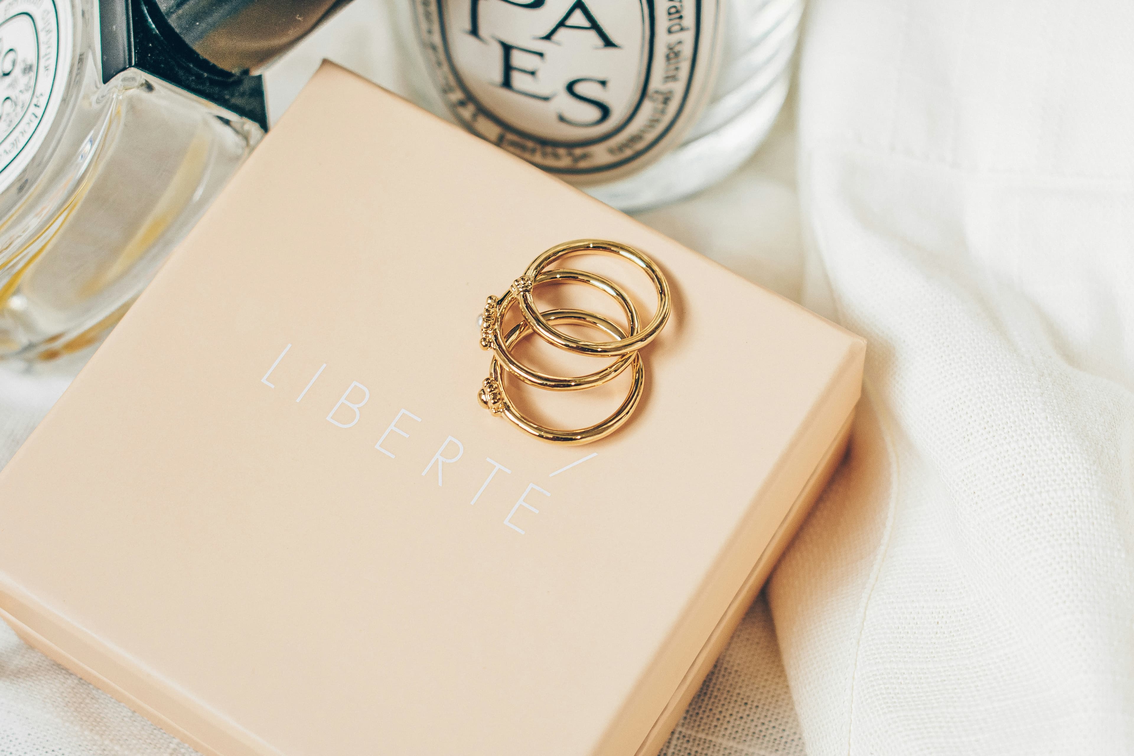 Polished gold hoops resting on a jeweller's box