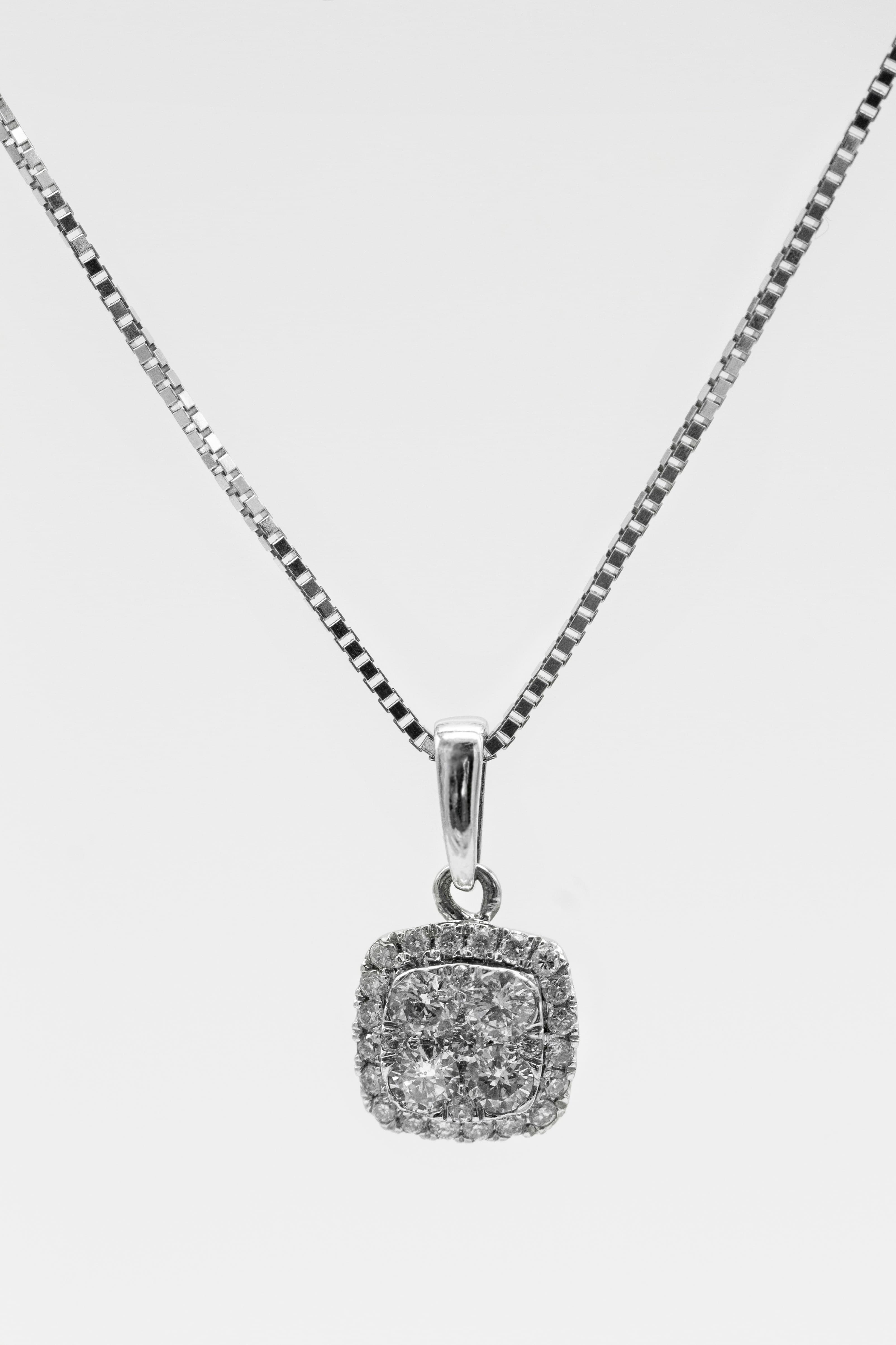 A diamond pendant on a fine chain against white