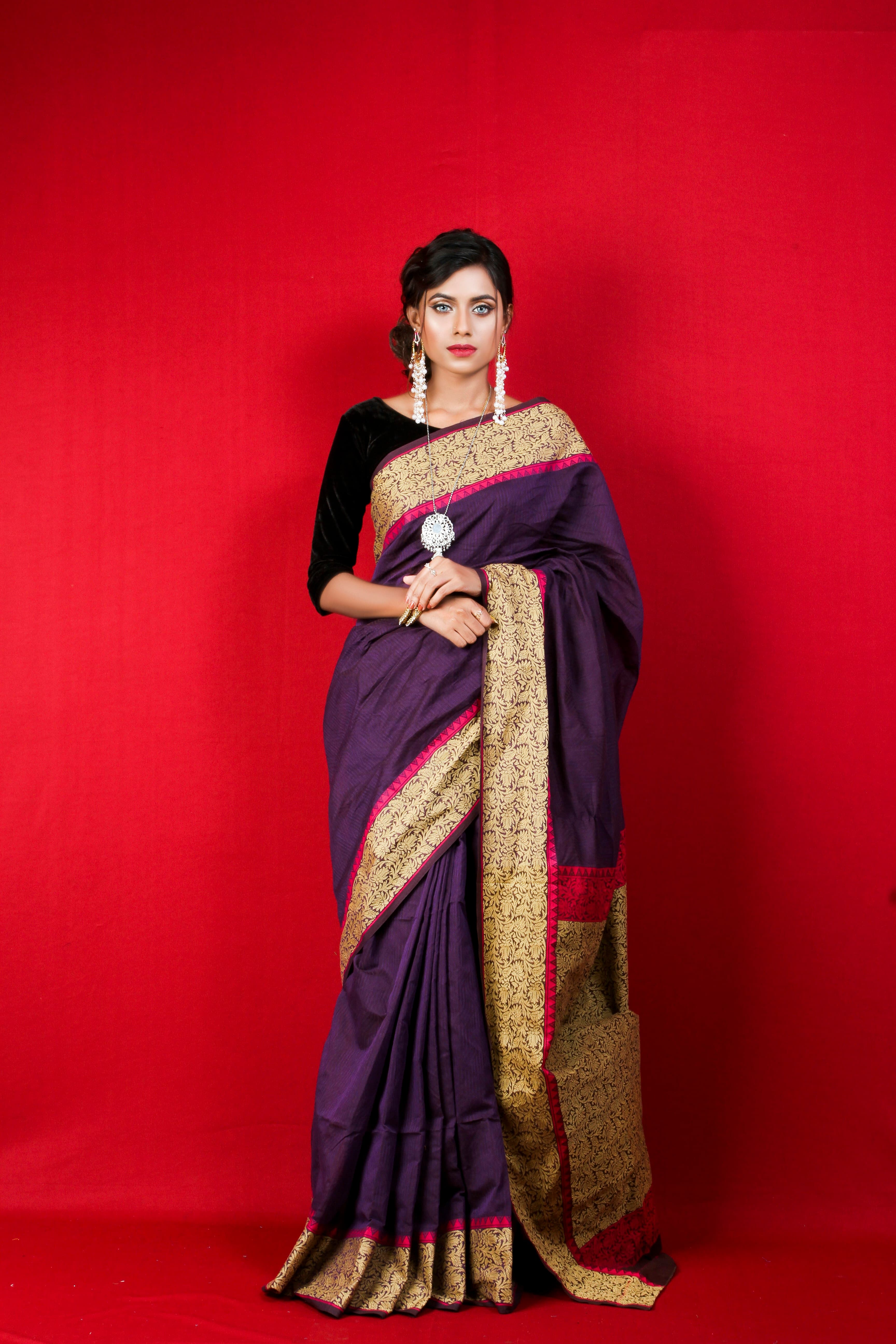 A bride in a silk saree wearing traditional gold