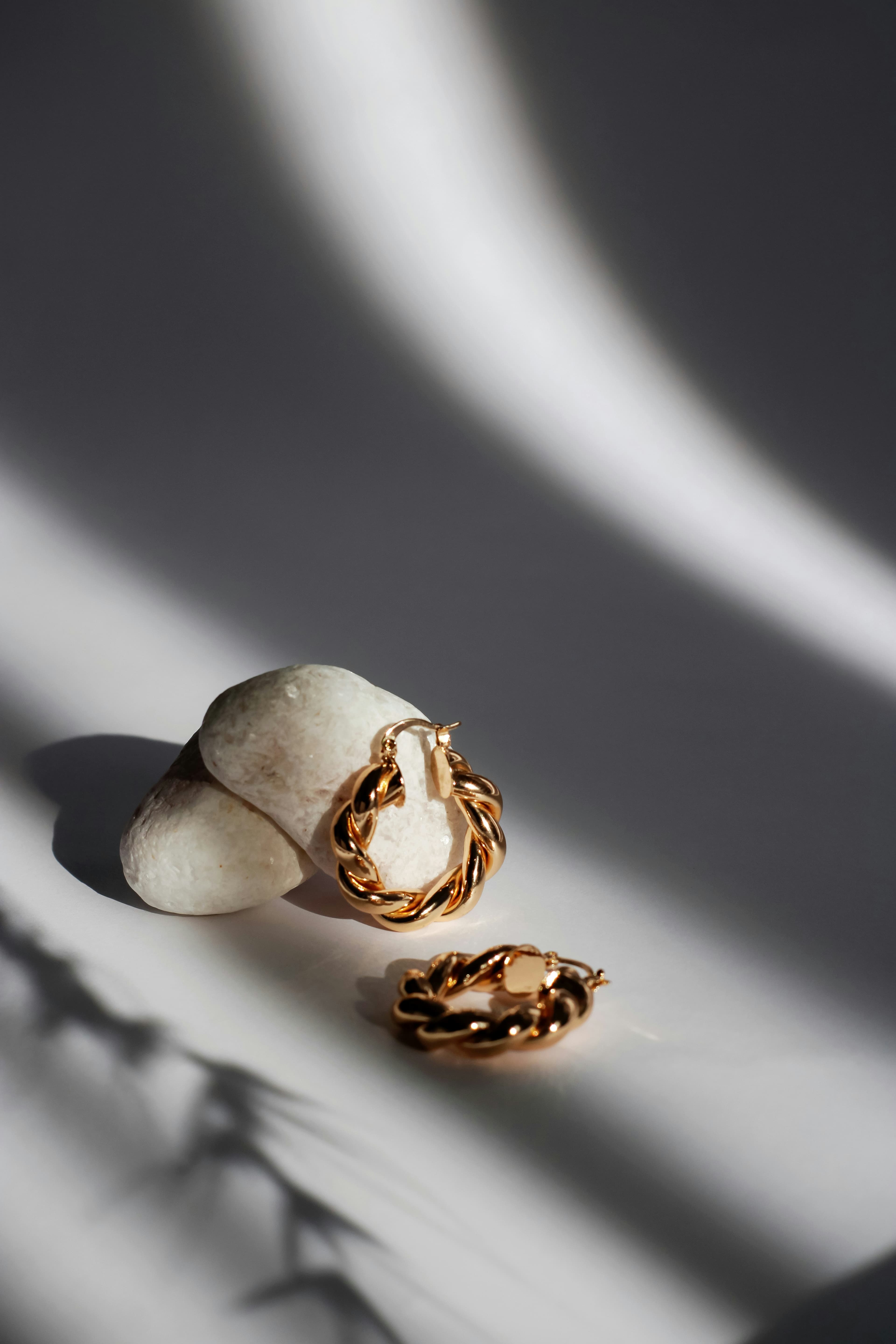 Gold rings laid out on marble in morning light