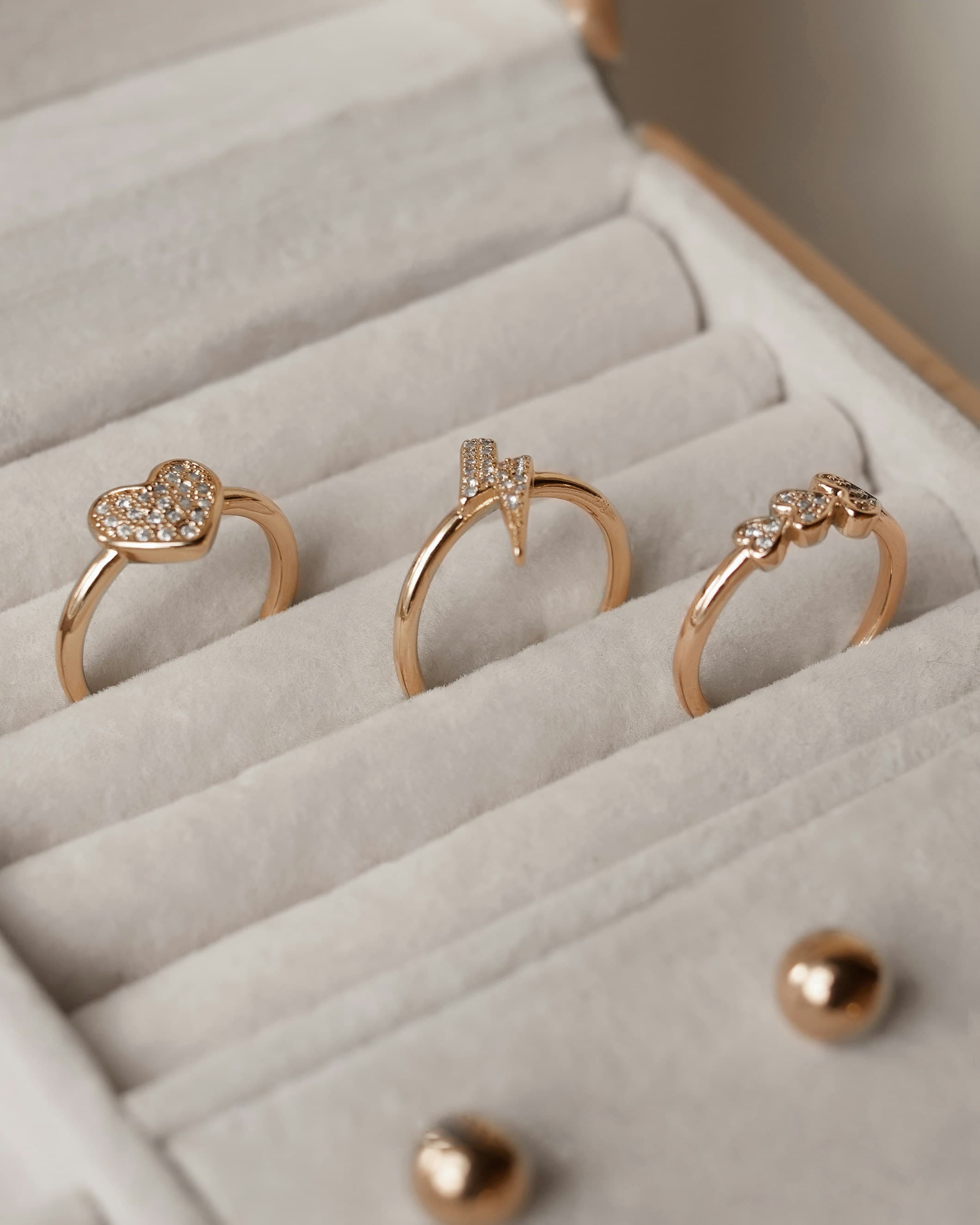 Gold rings seated in a velvet display tray