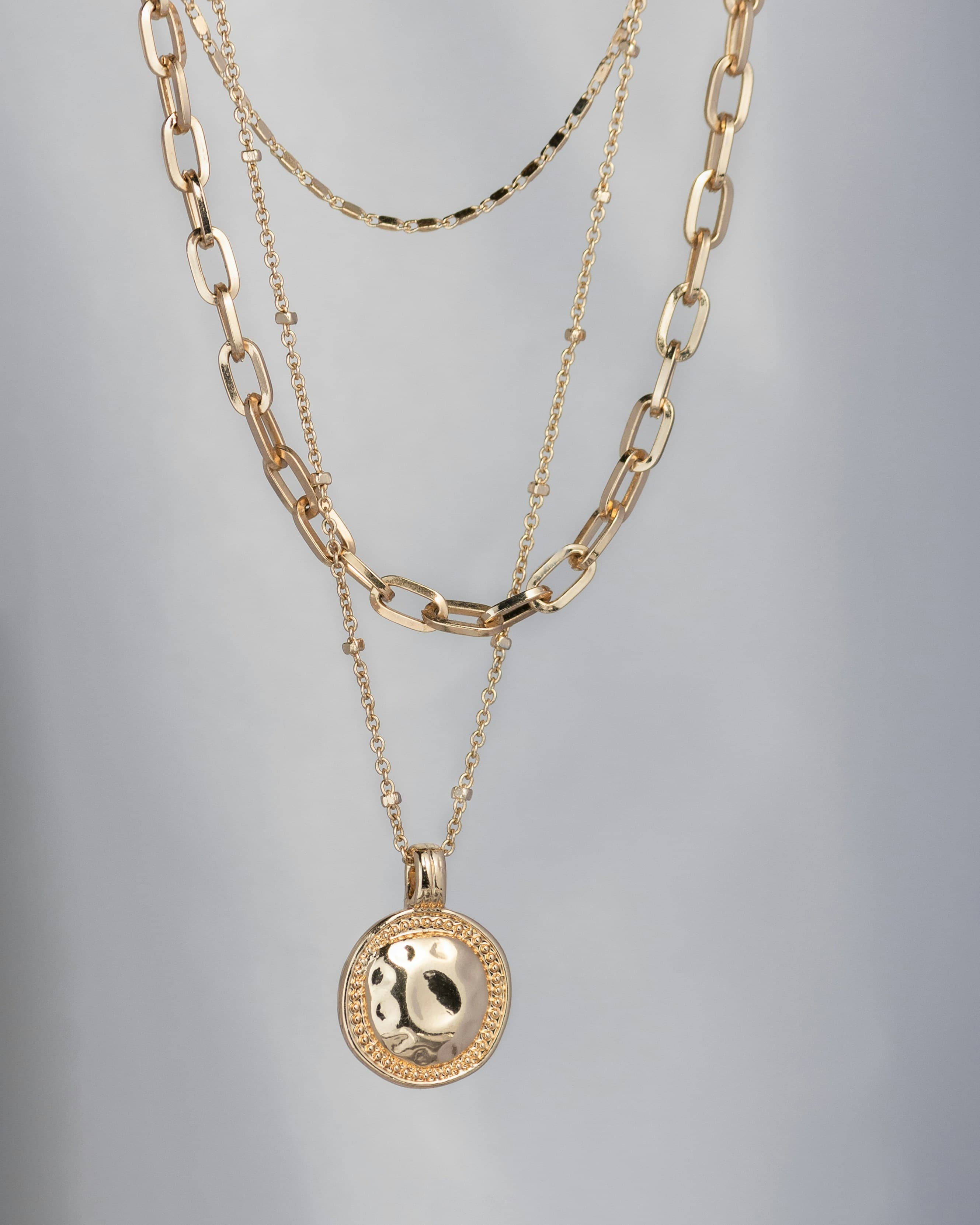 Finished gold chains and an engraved medallion pendant